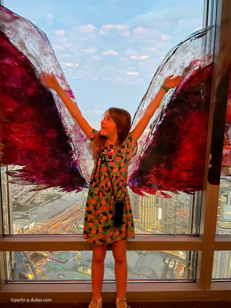 Angel wings are stuck to the windows of the Burj Khalifa for photo opportunities