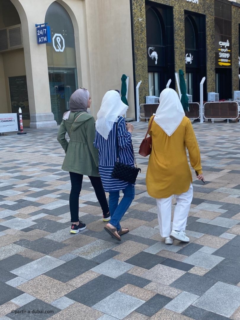 Women in Dubai cover their hair with a veil, a niqab, or a burqa
