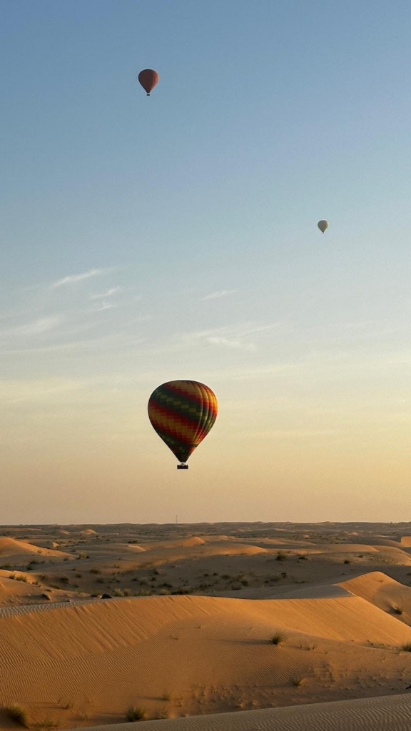 Hot air balloons over the sand dunes in the Dubai desert