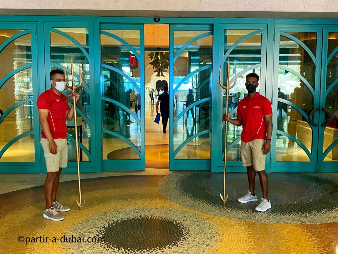 At the entrance to the water park, men holding tridents welcome visitors